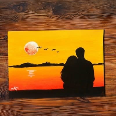 Couple sitting close to each other in a sunset