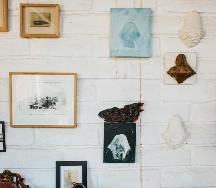 Portraits in Different Sizes Displayed on a Wall